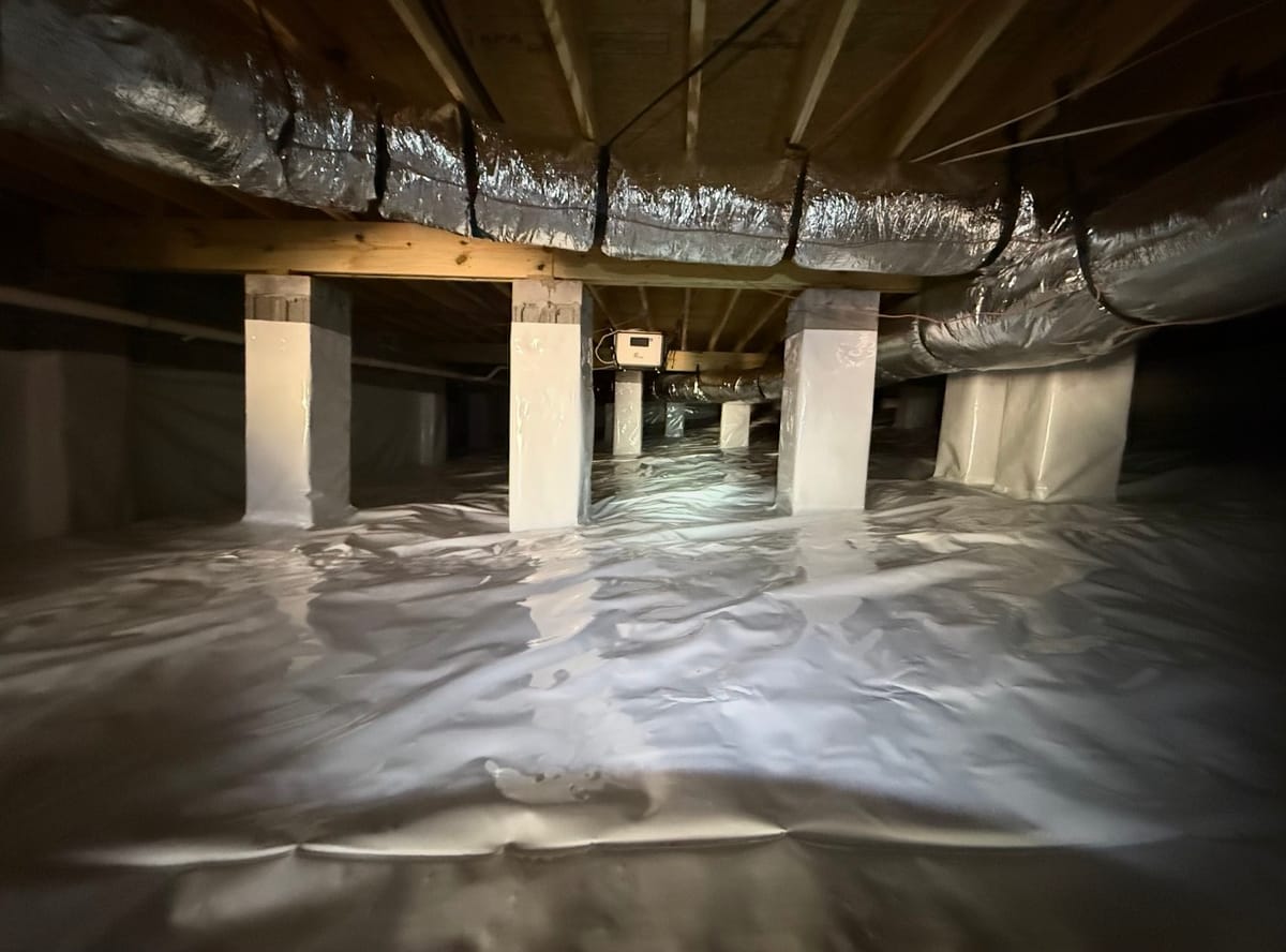 Sealed and Insulated Crawl Space with Vapor Barrier and Ductwork in Residential Basement Setting