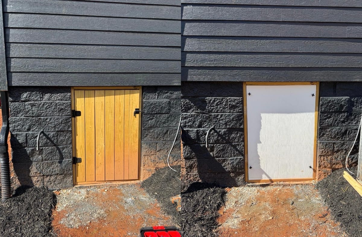 Side-by-Side Comparison of Wooden and Temporary White Doors in Black Brick Exterior with Surrounding Soil and Mulch