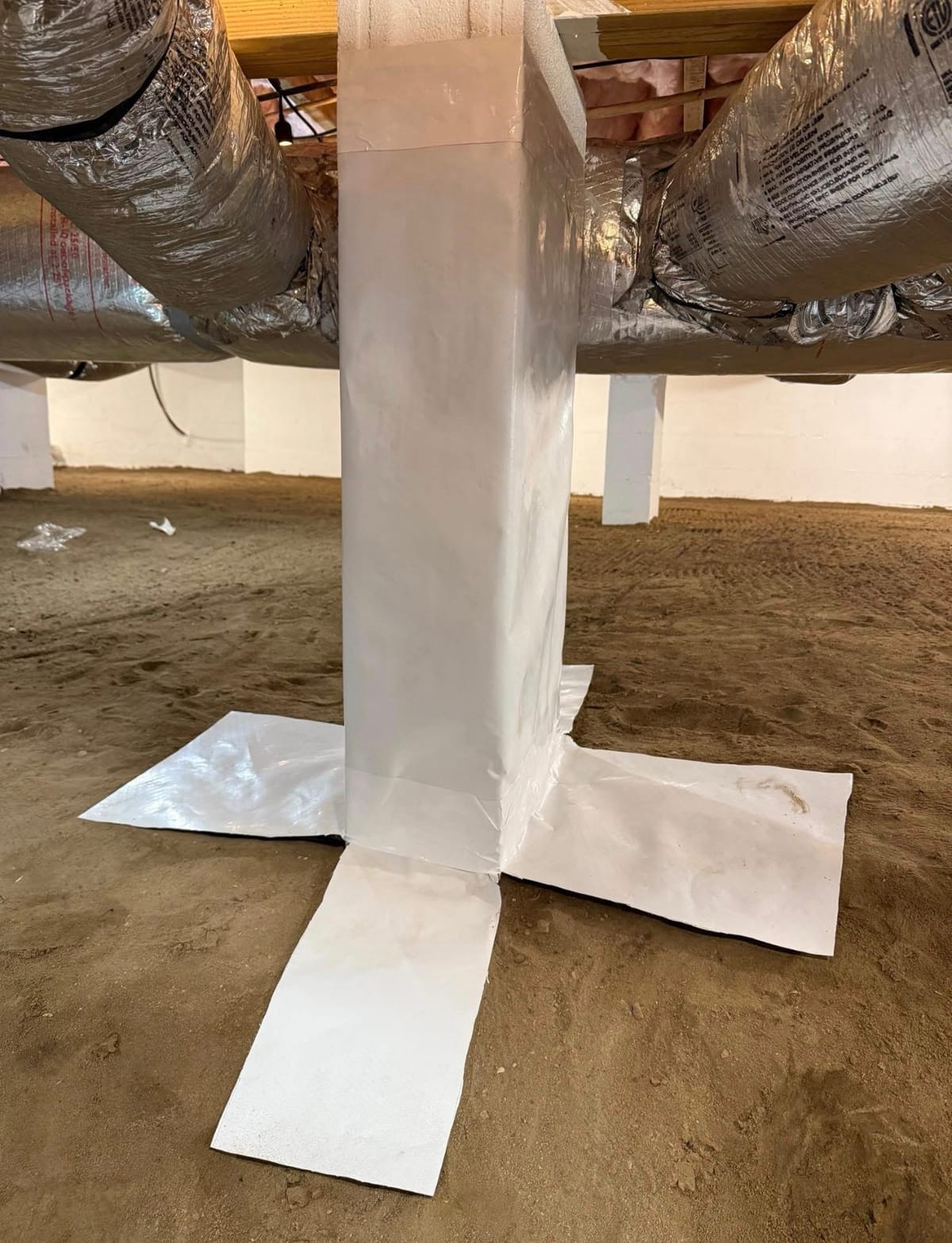 Sealed Support Beam in Crawl Space with Insulated Ductwork and Sandy Floor