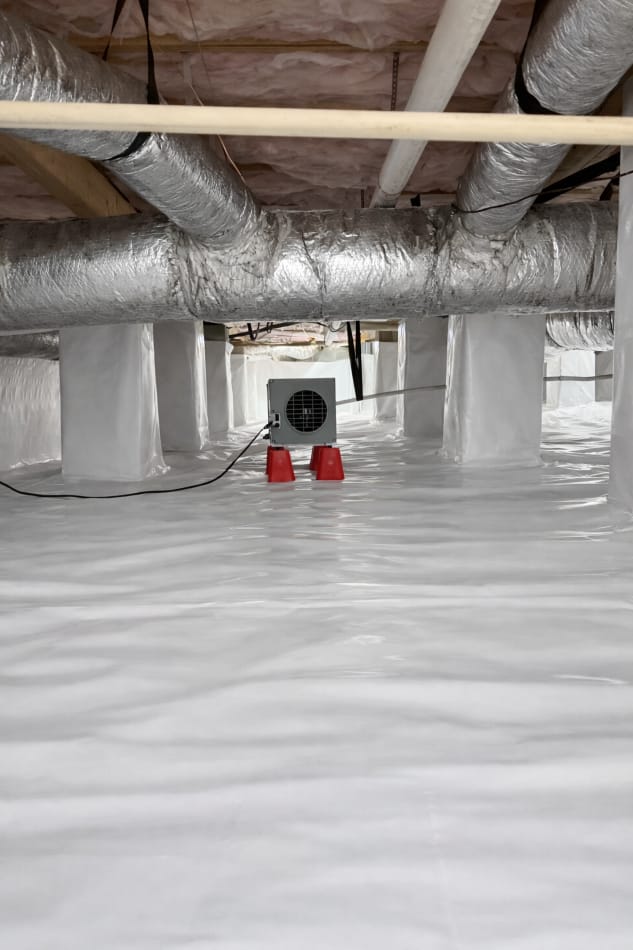 Crawl Space with Insulated Ductwork and Dehumidifier on White Vapor Barrier Lining