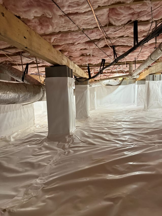 Crawl Space with White Vapor Barrier Lining and Exposed Insulation on Ceiling, Featuring Ductwork and Structural Support Beams