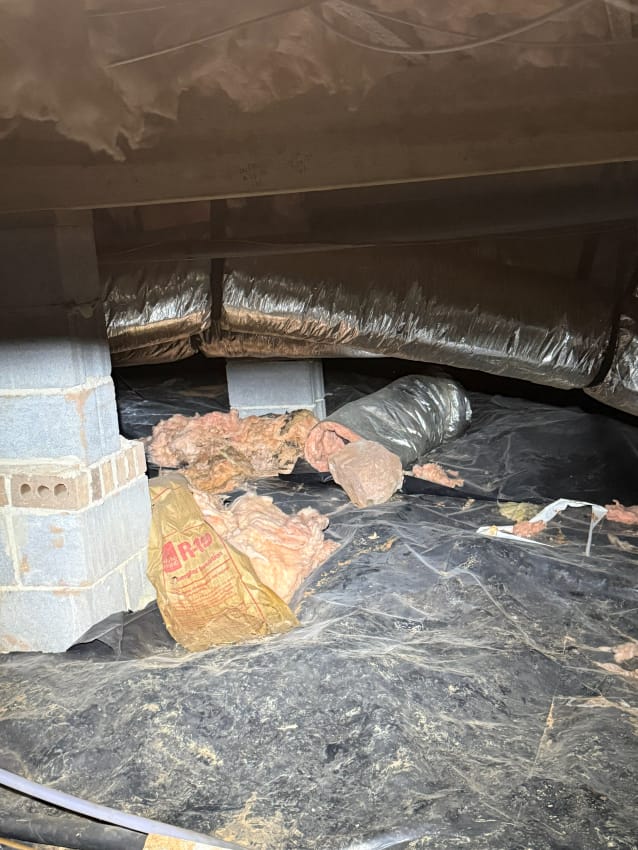 Crawl Space with Insulation Materials and Flexible Ductwork on Black Plastic Liner with Concrete Block Support Columns