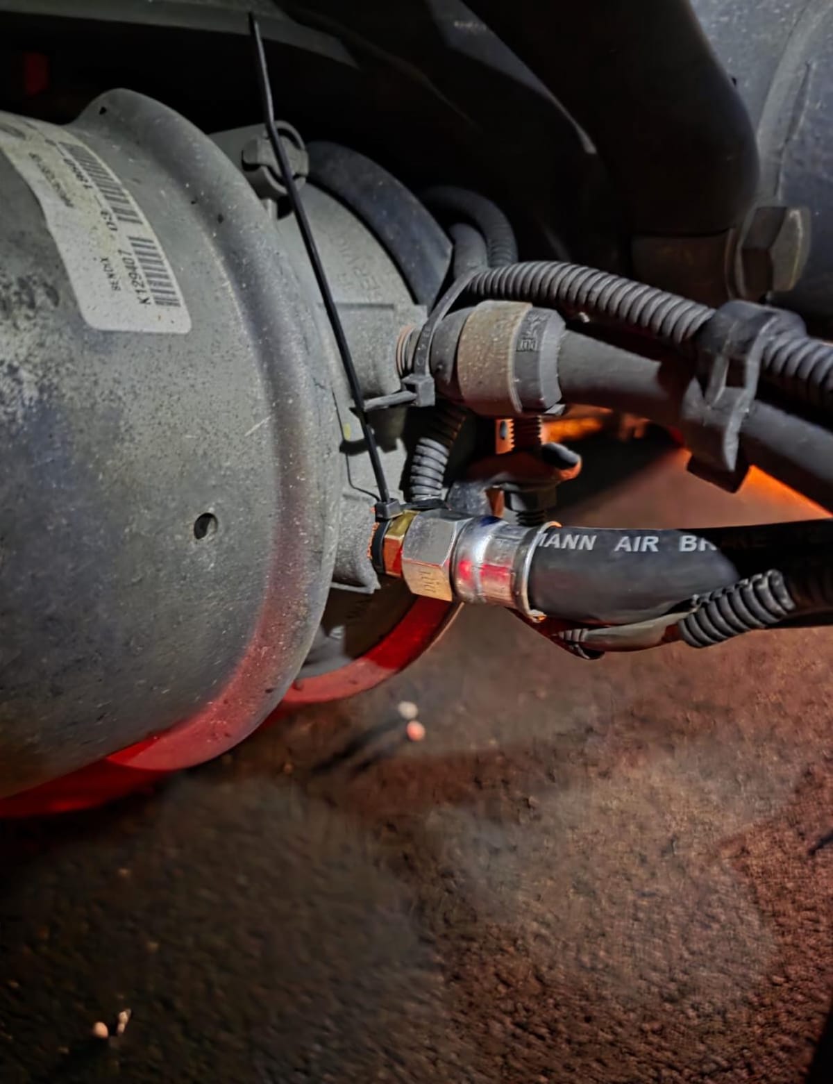 Close-Up of Industrial Air Brake System with Tubing and Wire Connections on Metal Cylinder Component