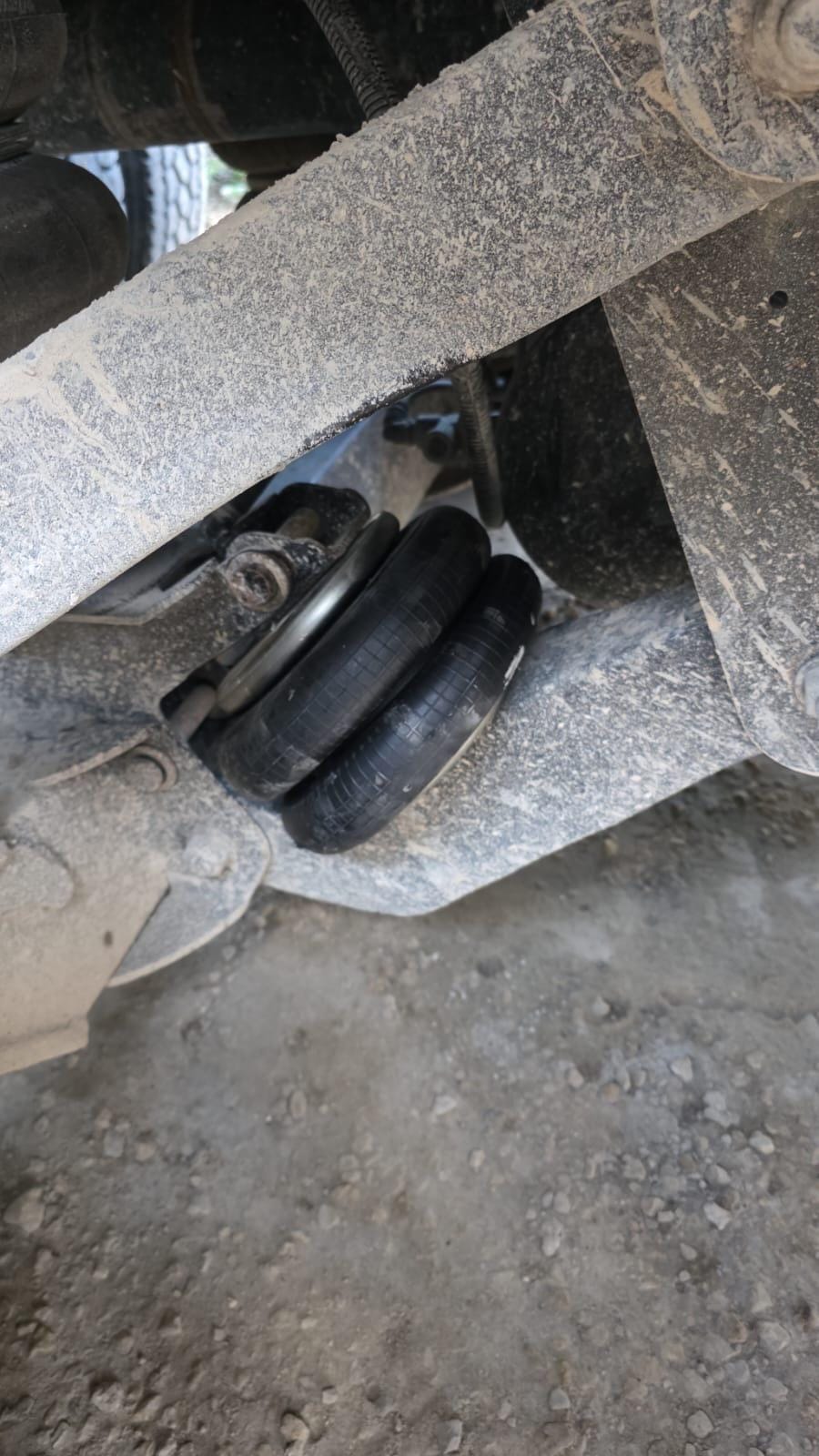 Close-Up View of Dusty Dual Air Suspension System on Industrial Vehicle Chassis