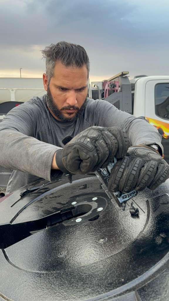 Man Working on Metal Equipment Outdoors