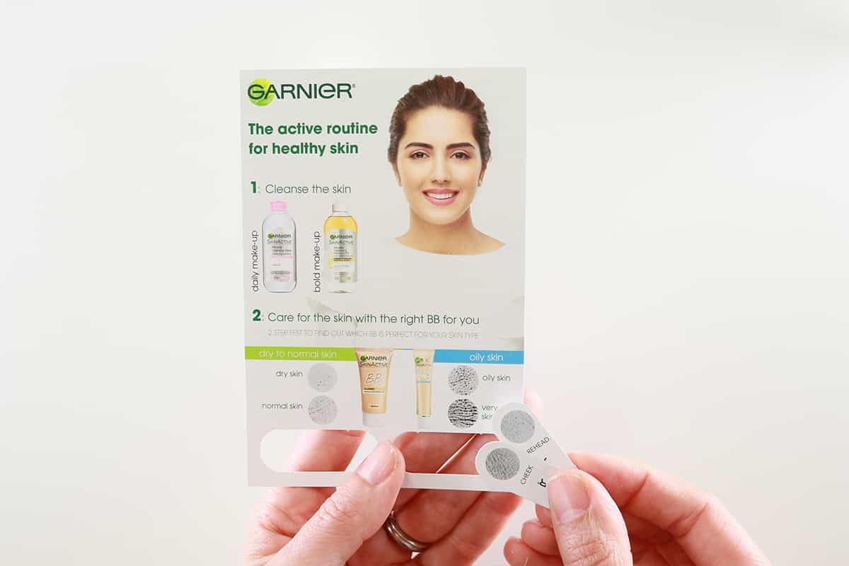 Garnier Skincare Routine Guide with Skin Type Test Strips Held by Hands, Featuring Model and Product Images for Cleansing and BB Cream Selection