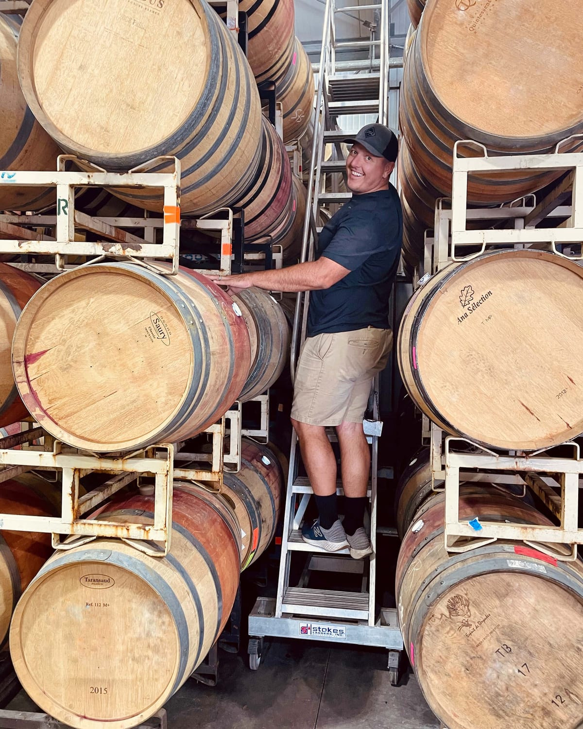 Fat Guy Tony Checking Wine Barrels in Cellar