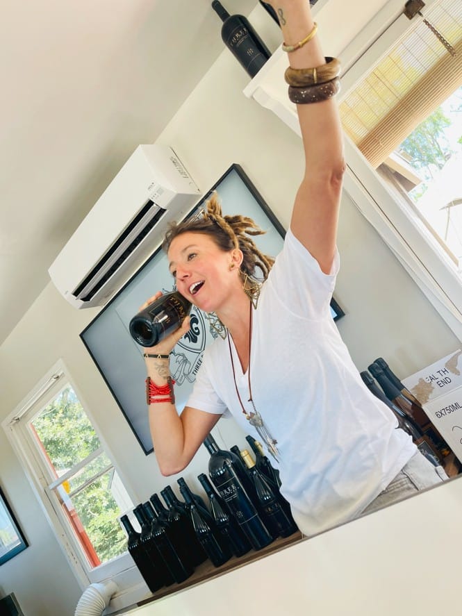 Joyful Woman Celebrating with Wine Bottles