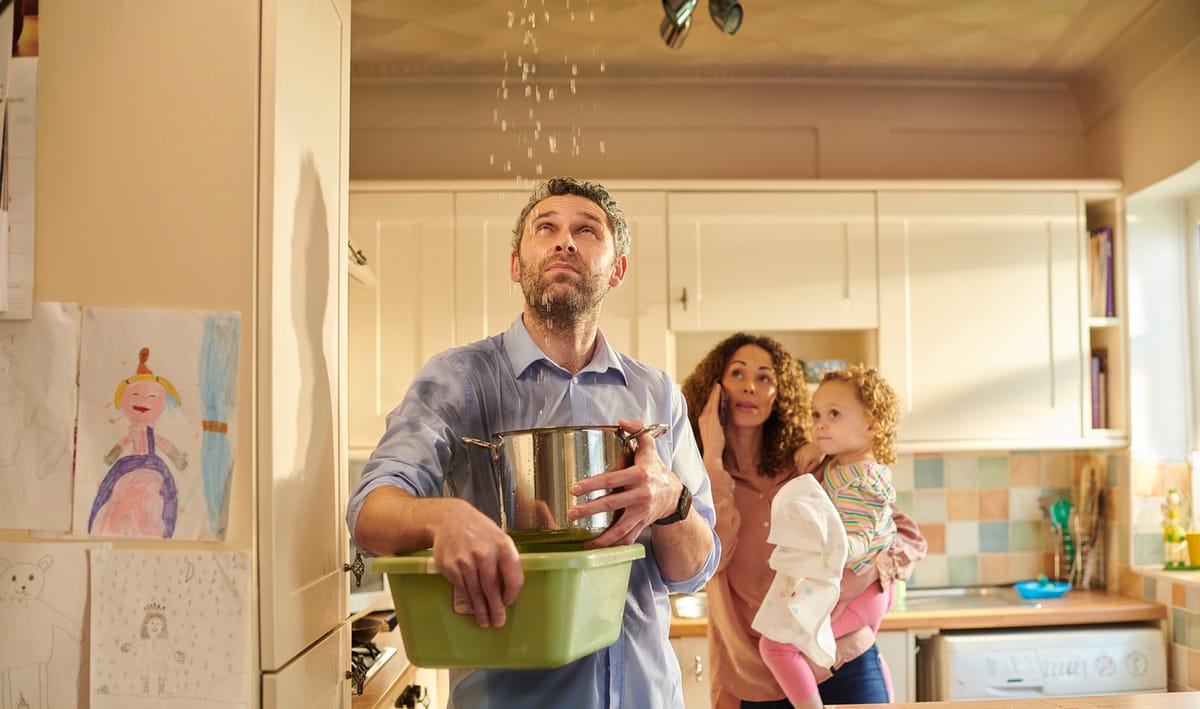 Family Managing Kitchen Leak with Father Holding Pots to Catch Dripping Water While Mother Calls for Help and Child Observes, Surrounded by Children's Drawings on Wall