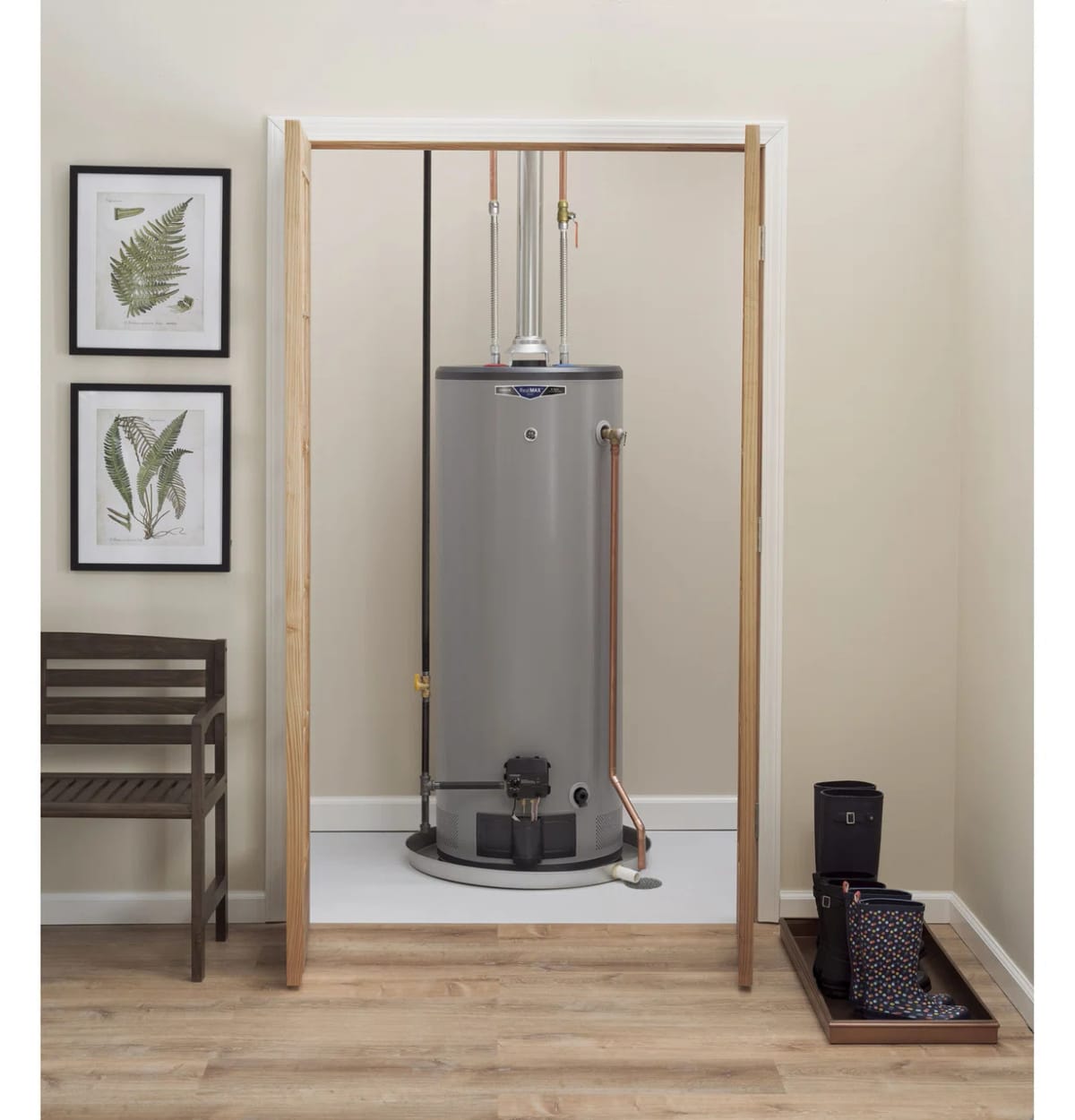 Utility Room with Tall Gray Water Heater, Wooden Bench, Botanical Wall Art, and Boot Tray on Light Wood Flooring
