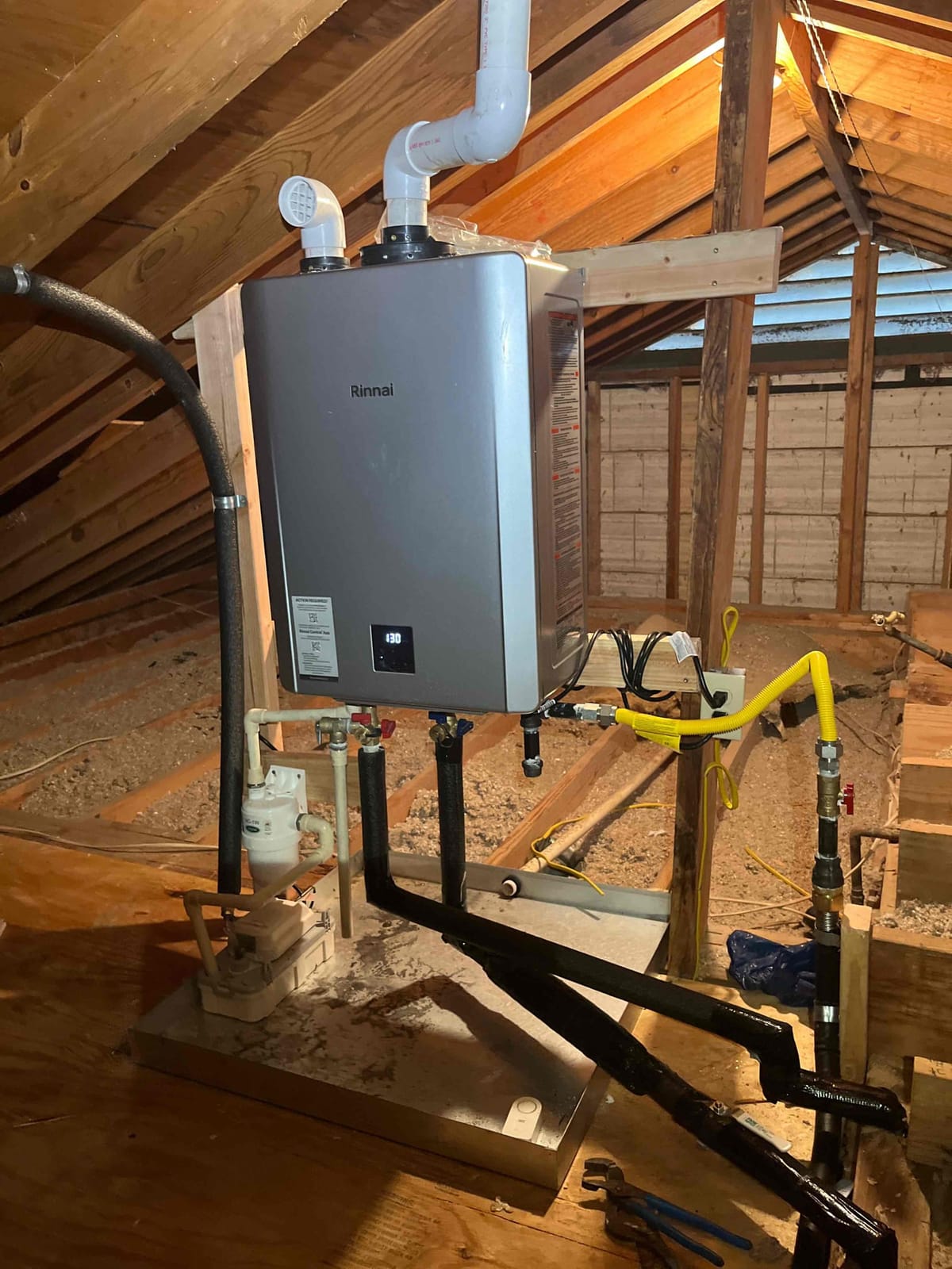 Tankless Water Heater Installation in Attic with Exposed Piping and Ventilation System