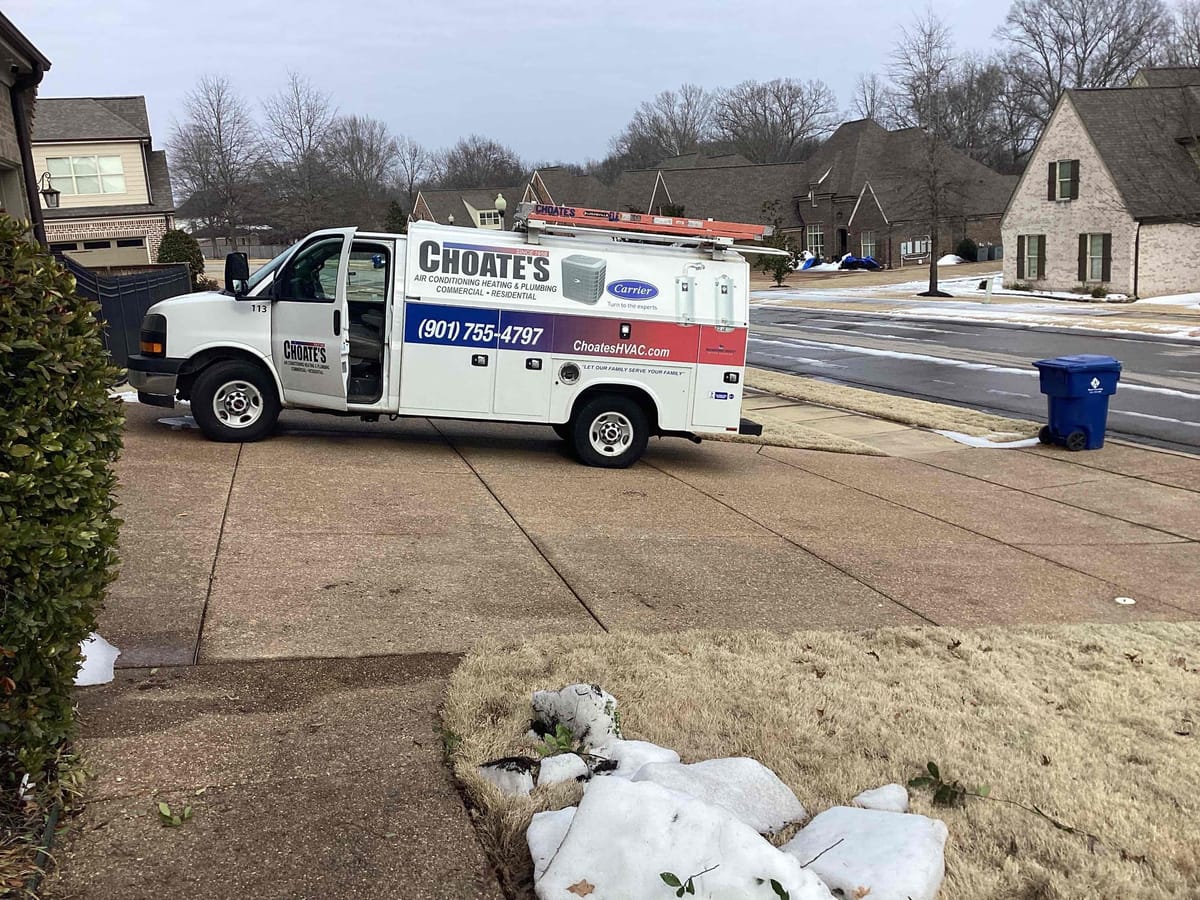 HVAC Service Van Parked on Suburban Driveway with Snow Patches and Trash Bin Nearby