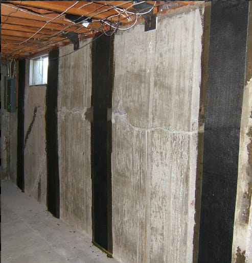 Reinforced Concrete Basement Wall with Carbon Fiber Strengthening Strips and Exposed Ceiling Wires