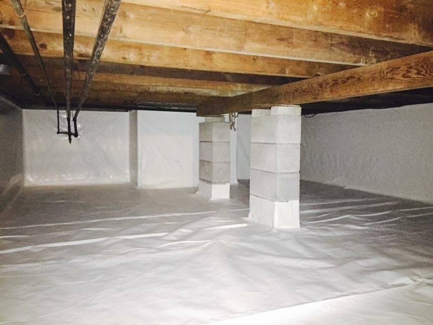 Clean and Sealed Crawl Space with Exposed Wooden Beams and Concrete Support Columns