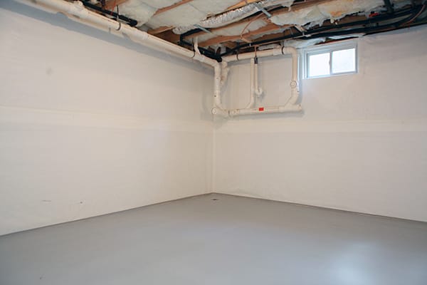 Unfinished Basement with Exposed Ceiling, Insulation, and Visible Plumbing Pipes Near Small Window