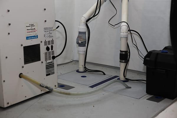 Basement Sump Pump System with PVC Piping and Dehumidifier Setup