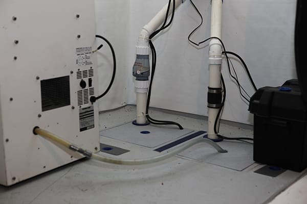 Basement Sump Pump System with Multiple Pipes and Electrical Wiring Installation